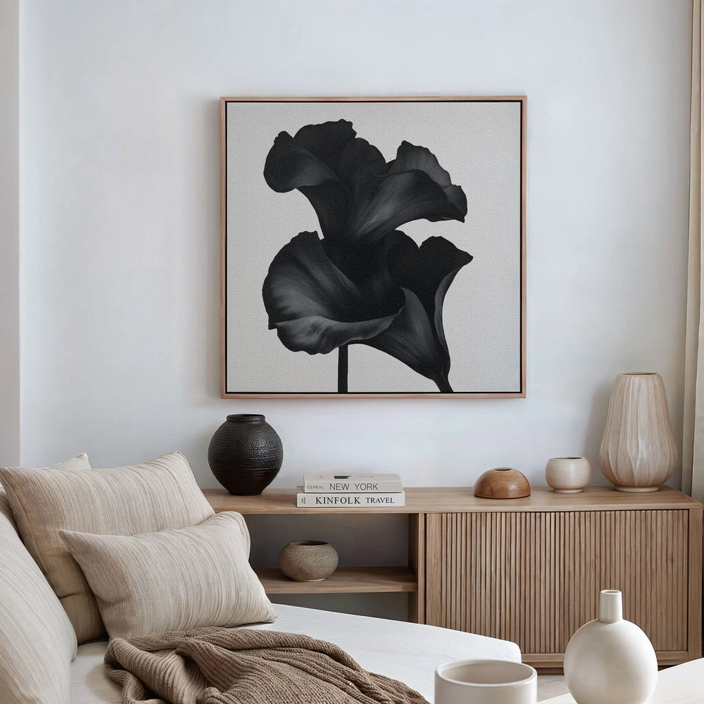 Minimalist living room featuring a beige sofa, cushions, wooden sideboard, neutral decor accents, and the Noir Bloom Canvas Art - Square above the cabinet—ideal for those wanting stylish modern living room decor.