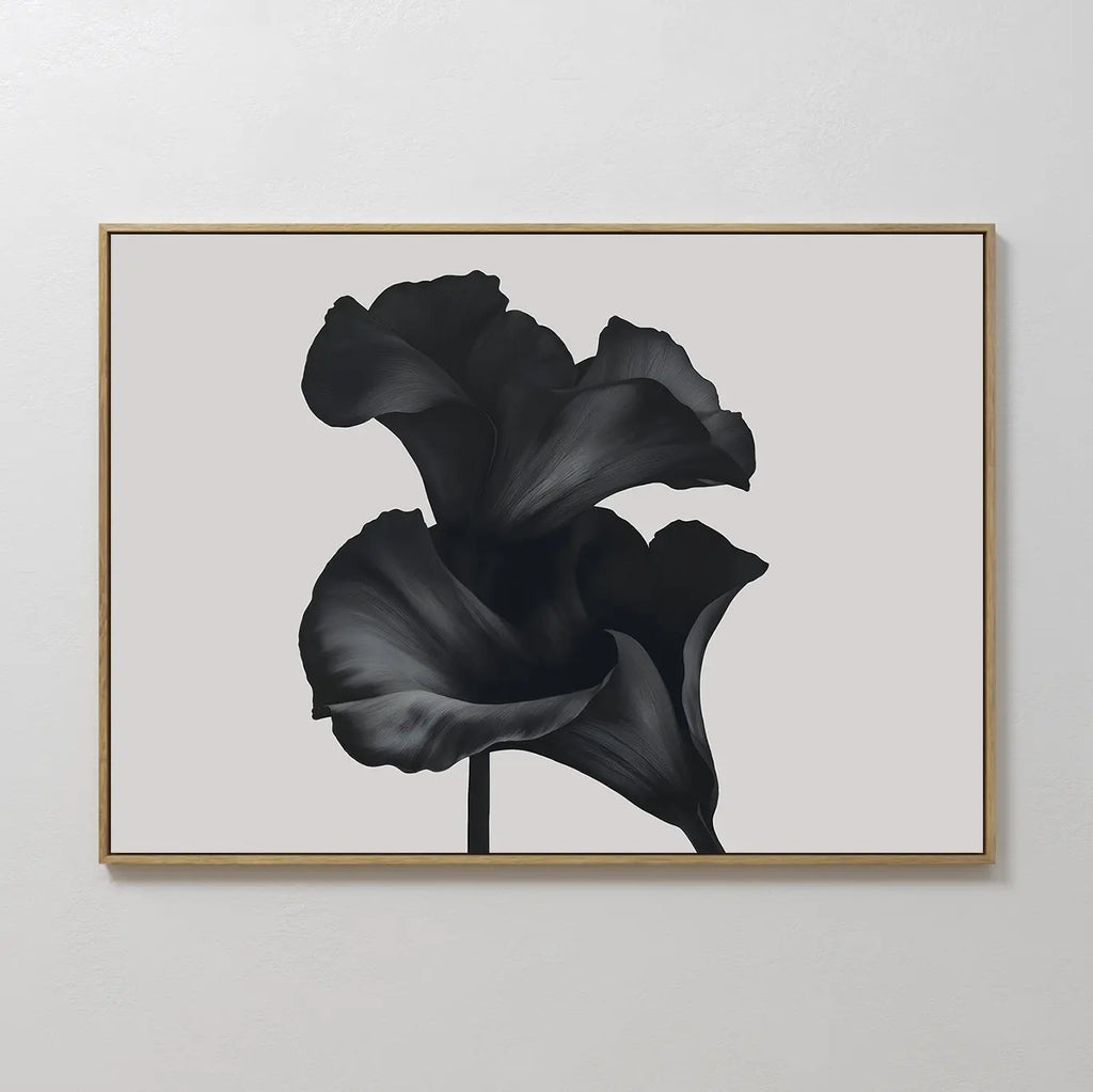 Noir Bloom Canvas Art – Horizontal features two large black calla lilies with overlapping petals on a light gray background, framed in slim gold—an ideal minimalist wall art piece for modern living room decor.