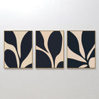 The Noir Blossom Set of 3 features framed minimalist wall art prints with bold black and beige organic shapes, displayed side by side to create a cohesive modern design on any white wall.