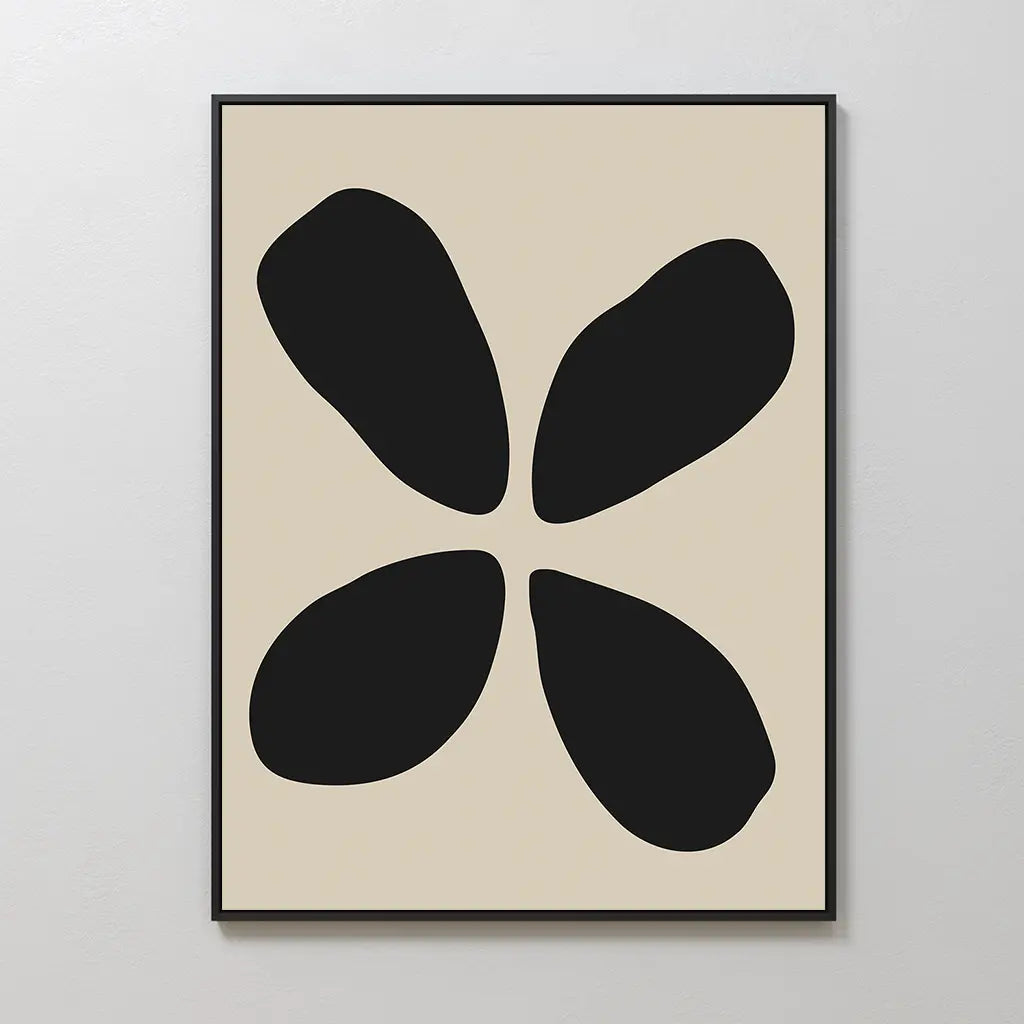 Noir Botanica Canvas Art: Minimalist wall print with four irregular black petal-like shapes arranged in a circle on a beige background, framed in black—ideal for modern decor.