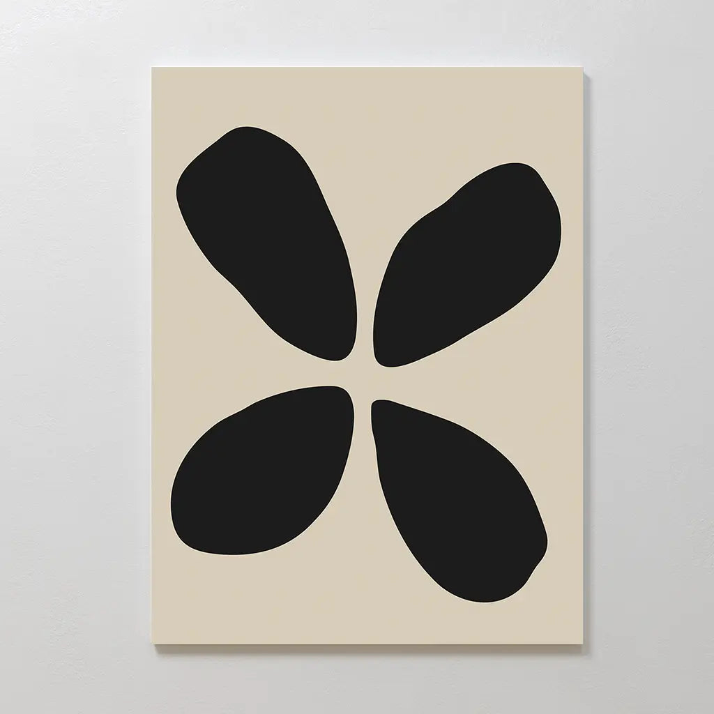 The Noir Botanica Canvas Art displays four bold, irregular black forms on a beige background, arranged in a loose symmetry reminiscent of petals—ideal for modern or minimalist wall decor.
