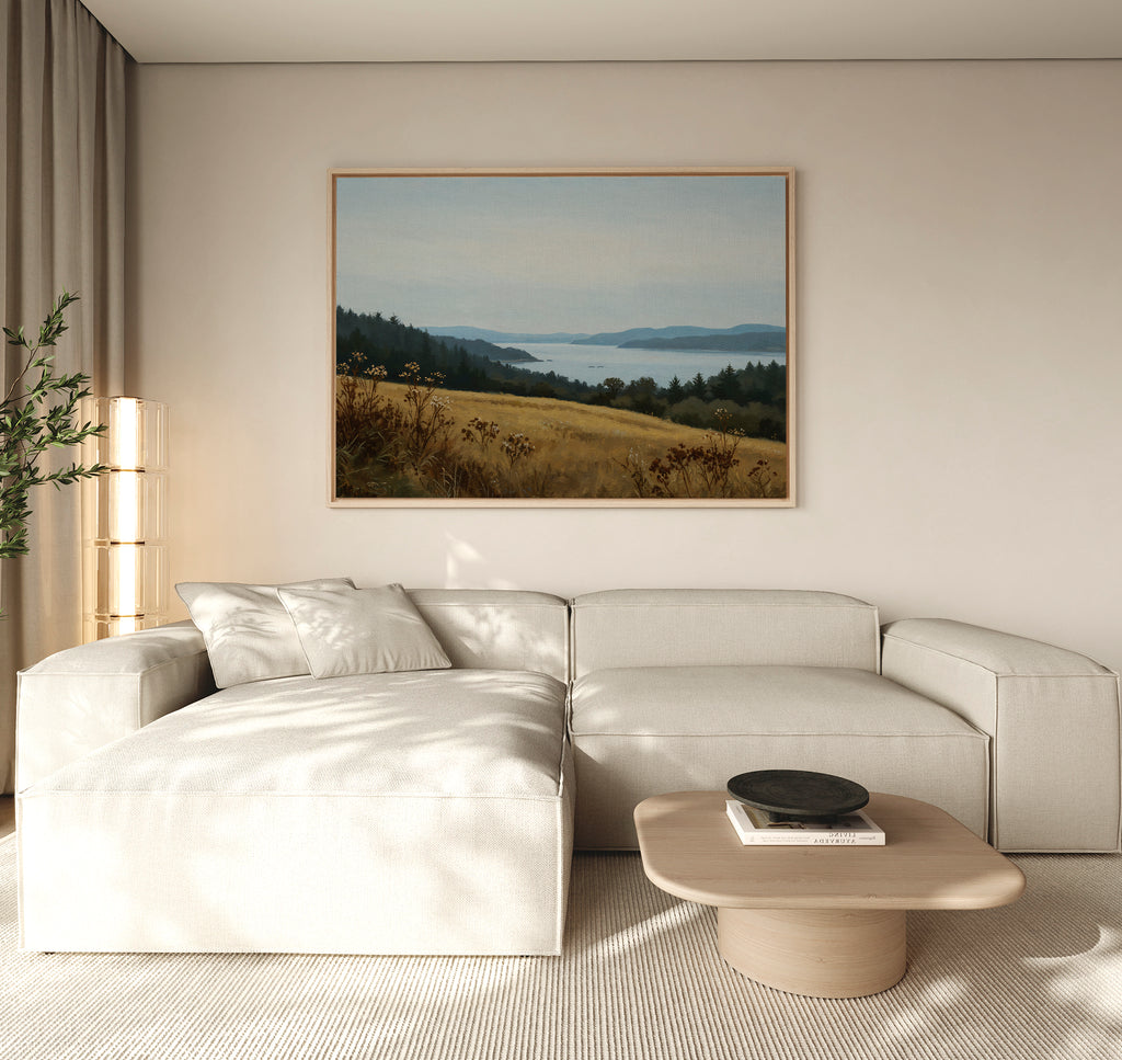 A modern living room featuring a light beige sectional sofa, low wooden coffee table, tall plant, and the Northern Silence Canvas Art as minimalist wall art on a neutral wall for an elegant decor touch.