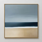 The Ocean Edge Canvas Art features a minimalist beach scene with a sandy shore, deep blue ocean, and cloudy sky in a gold frame—ideal abstract wall decor to bring tranquility to your space.