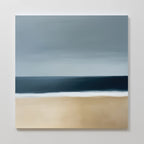 Ocean Edge Canvas Art is a minimalist painting featuring a sandy beige beach, dark blue sea, white shoreline, and muted blue sky—perfect as coastal wall art with its serene, simple composition and soft horizontal brushstrokes.