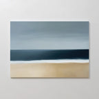 The Ocean Edge Canvas Art – Horizontal is a minimalist abstract piece with soft brushstrokes, depicting a sandy beach, white surf, and deep blue ocean under a cloudy gray sky.