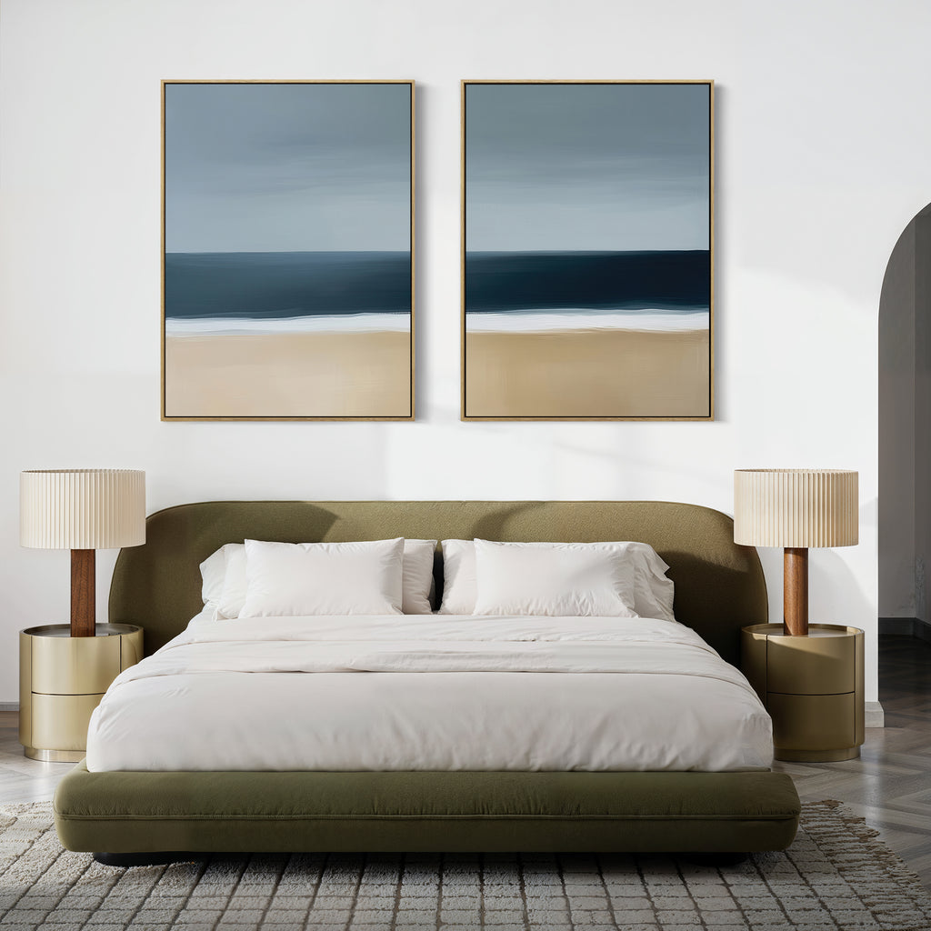 Modern bedroom featuring an olive green bed with white bedding, beige nightstands with matching lamps, a textured rug, and the Ocean Edge Set of 2 coastal wall art above the bed on a white wall.