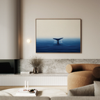 A modern living room showcases a neutral palette, a rounded beige armchair, a marble-topped console, and the Ocean Giant Canvas Art depicting a whales tail above blue water, adding to the serene ambiance above the console.