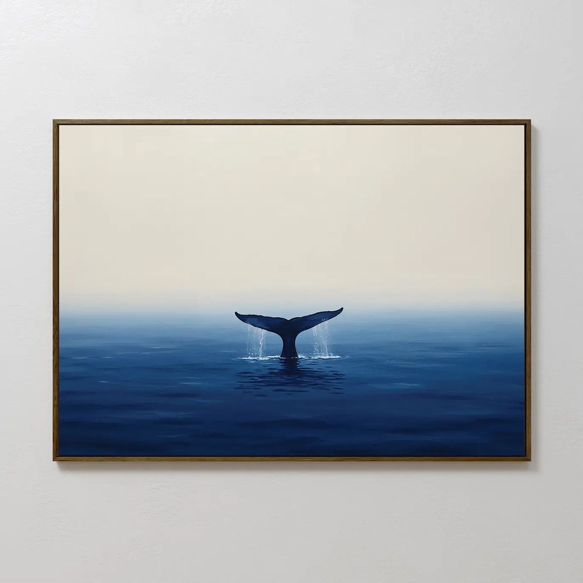 The Ocean Giant Canvas Art shows a whale’s tail rising from a calm blue sea with gentle splashes, set on a minimal light background. This striking coastal wall art is perfect for hanging on any white wall.
