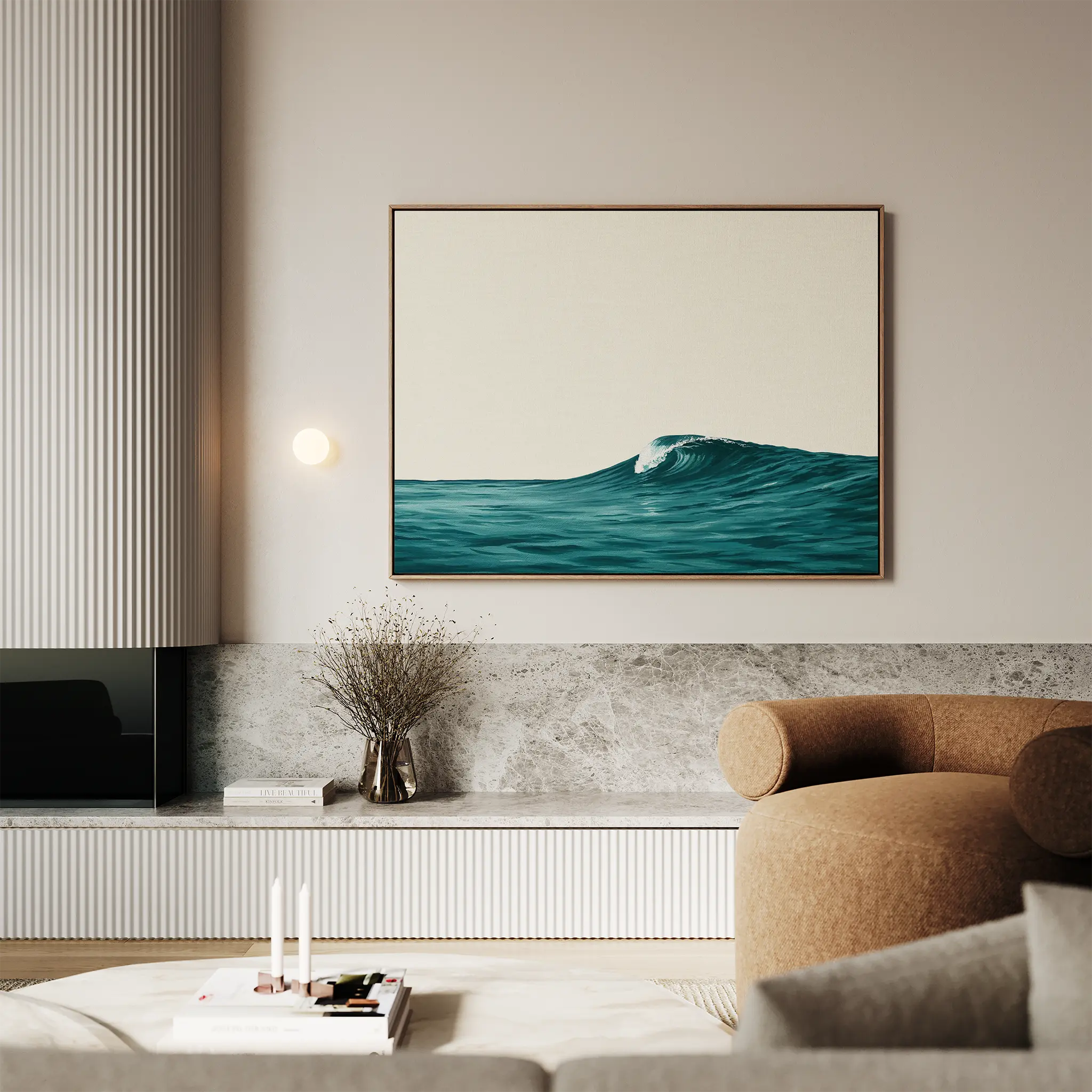 A modern living room features a beige sofa, marble accents, and minimalist decor; the Oceanside Crest Canvas Art hangs above a sideboard with a vase of dried branches, completing the chic coastal style.