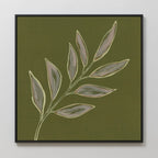 The Olive Branch Canvas Art features a minimalist painting of a leafy branch with eight leaves in light green and tan on an olive background, framed in black—an ideal accent for modern living room decor.