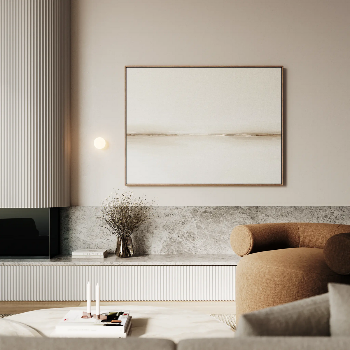 A modern living room with neutral tones features the Pale Desert Canvas Art, a round tan armchair, a gray marble shelf with a vase of dried flowers, and minimalistic decor.