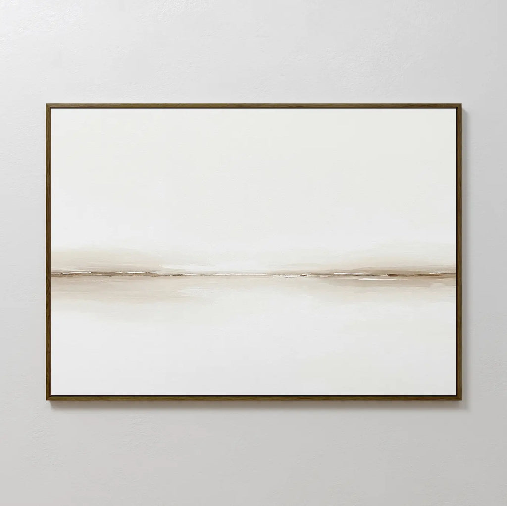 Pale Desert Canvas Art showcases a minimalist, horizontal beige line on a white canvas in a slim dark frame—ideal for contemporary living room decor and perfect on light grey walls.