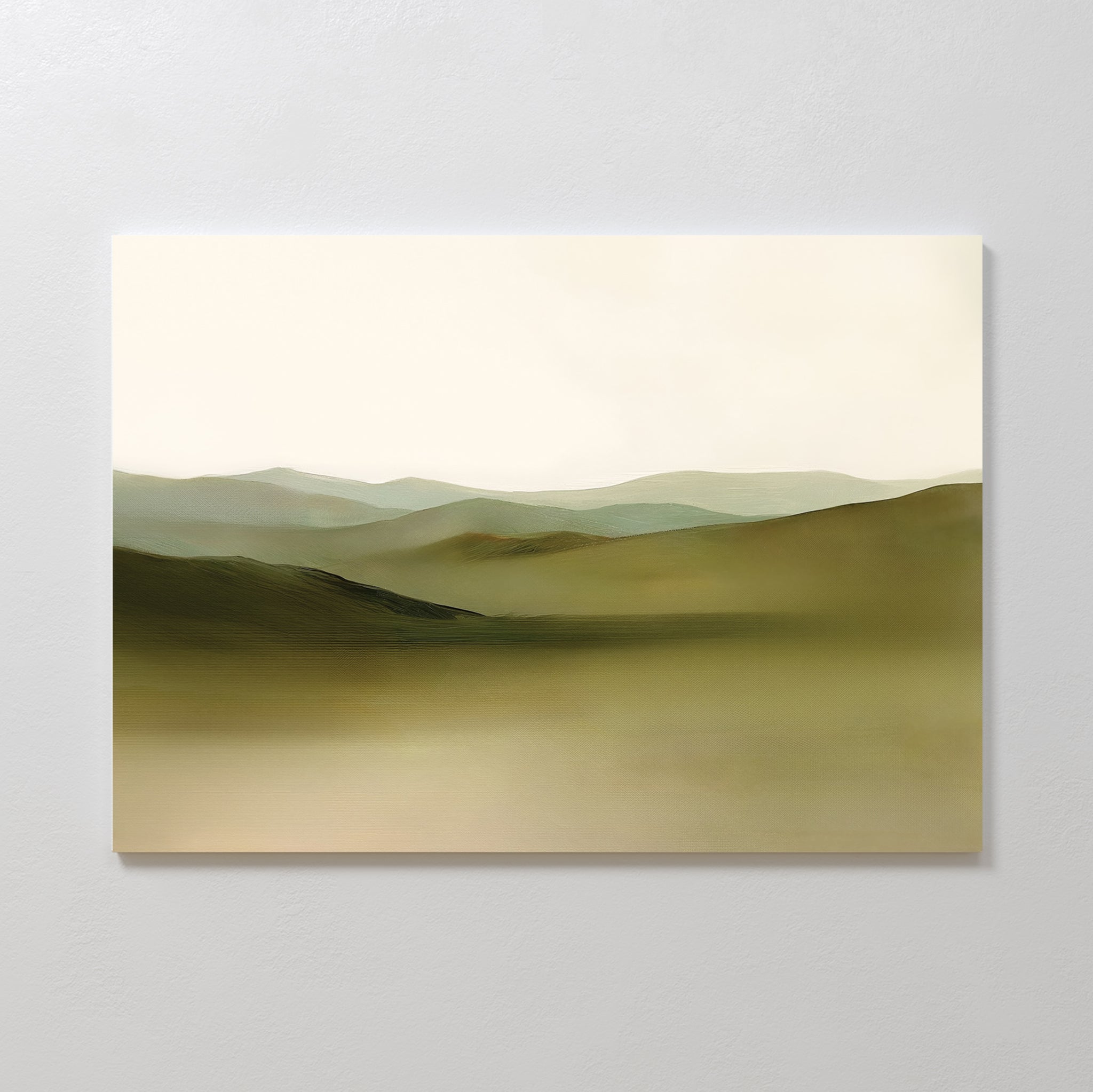 Pastoral Peace Canvas Art features soft, rolling hills in muted green and brown beneath a pale sky, mounted on a light wall—ideal as serene wall art to add calm and enhance minimalist decor.