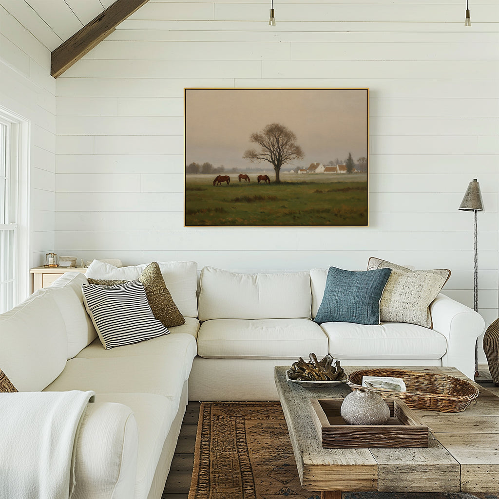 A cozy living room with a white sectional sofa, assorted throw pillows, a wooden coffee table with decor, and the Pasture Morning Canvas Art featuring horses in a field displayed above the seating area.