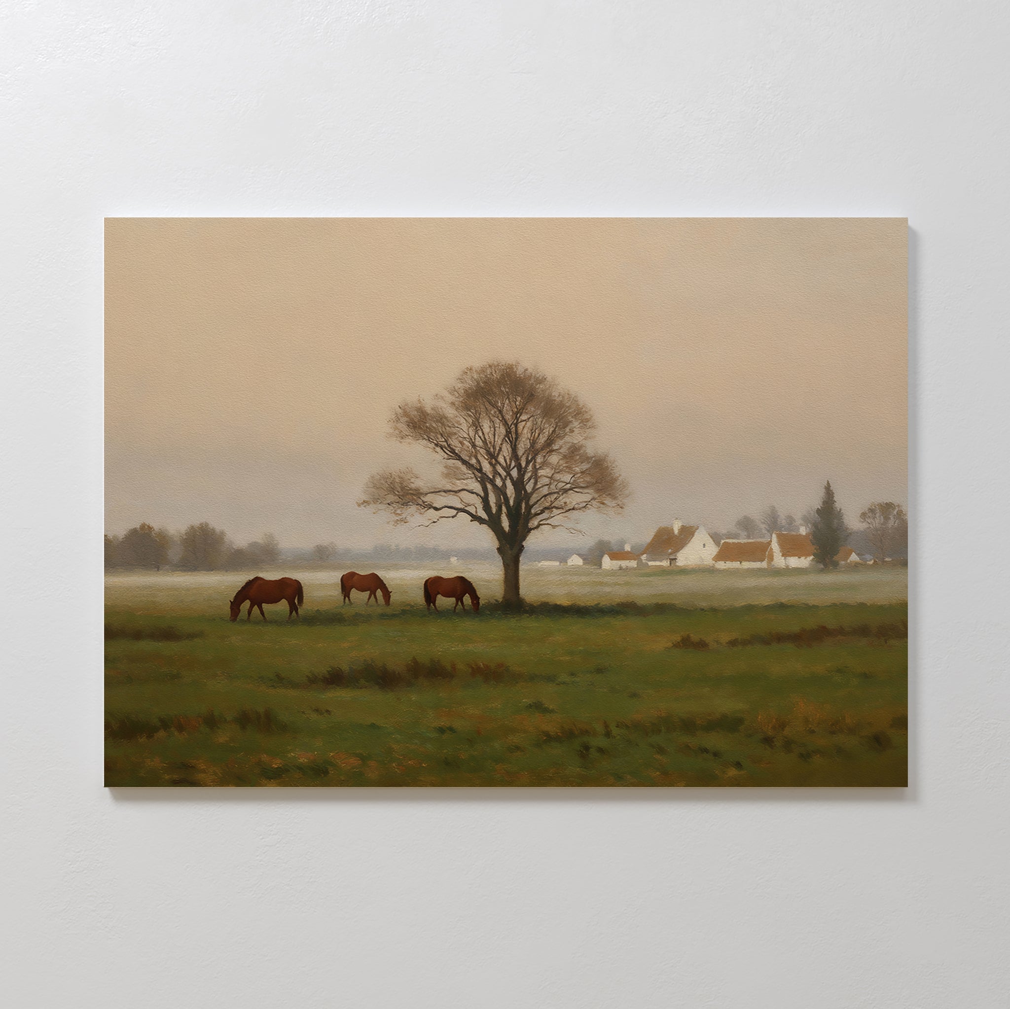 Pasture Morning Canvas Art depicts three horses grazing in a green field beneath a leafless tree, with white houses and trees in the background under a cloudy sky—ideal countryside decor for rural scene lovers.