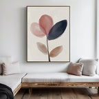 Minimalist living room with two wooden sofas, light cushions, and the Petal Breeze Canvas Art—large modern floral wall art in soft pink, navy, and beige petals on a white wall—ideal for stylish living room decor.