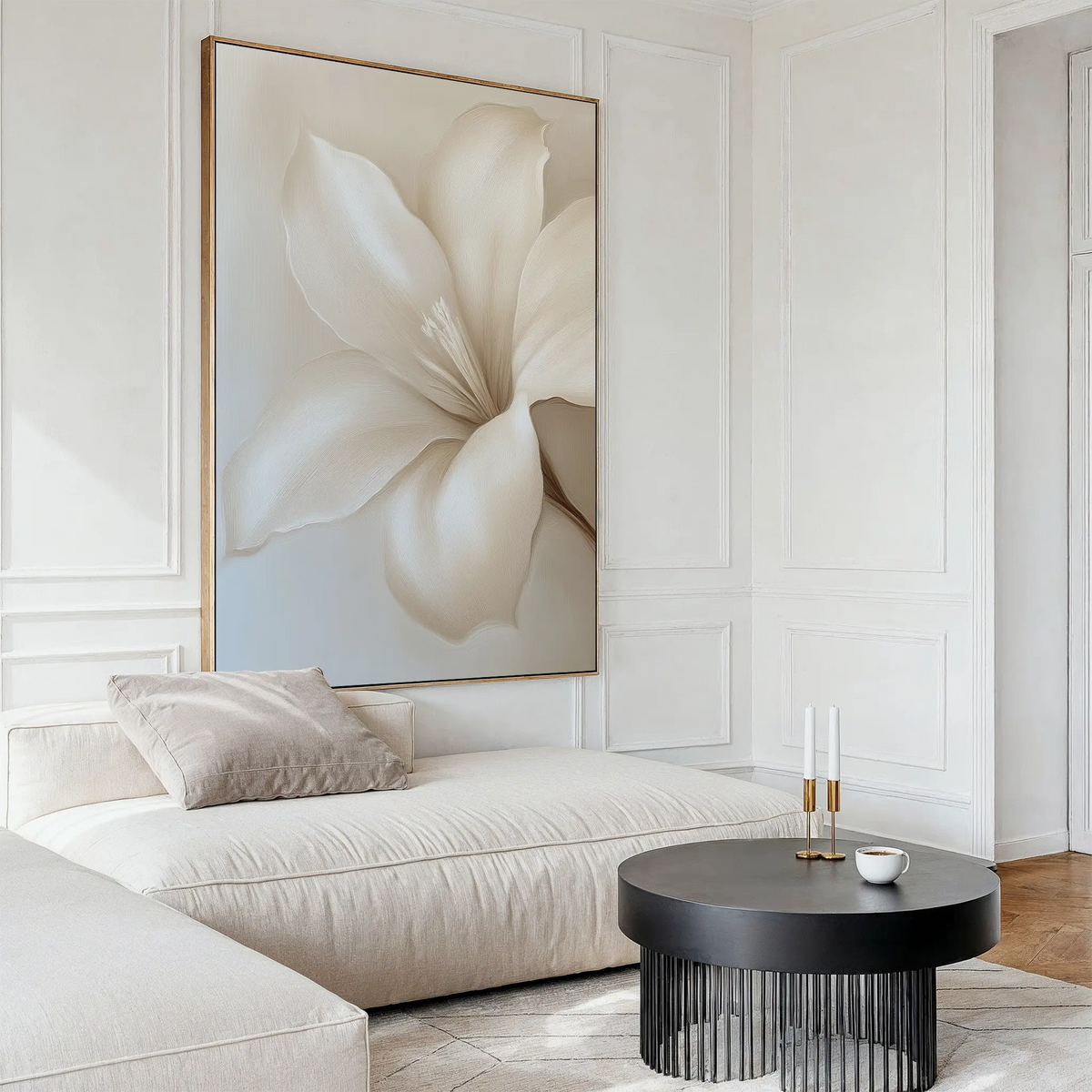 A modern living room featuring cream-colored furniture, the Pure Magnolia Canvas Art as minimalist wall decor, a round black coffee table, and gentle natural light.