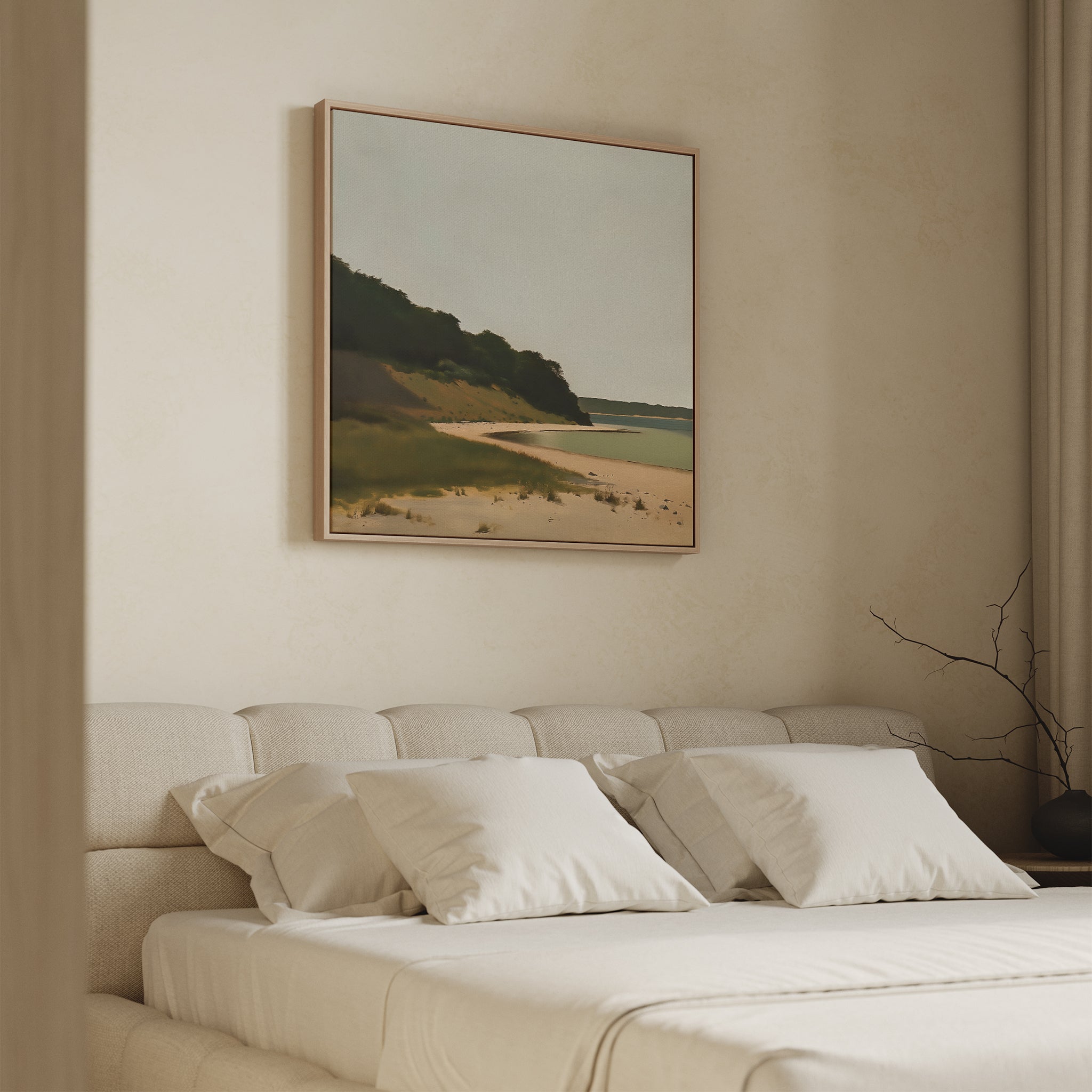 A cozy, minimal bedroom features a beige bed, white pillows, and Quiet Bend Canvas Art—a serene landscape with beach and greenery—above the headboard. Neutral walls and simple decor complete the calm, tranquil vibe.