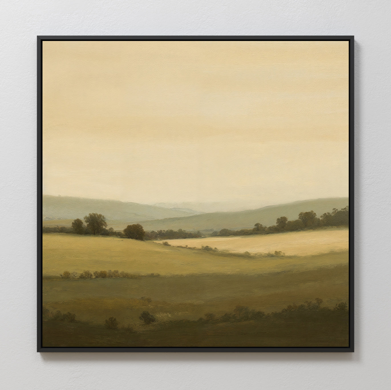 Quiet Countryside Canvas Art: Framed minimalist wall art depicting a sunlit countryside with rolling hills, green fields, scattered trees, and a hazy sky for a peaceful, serene touch.