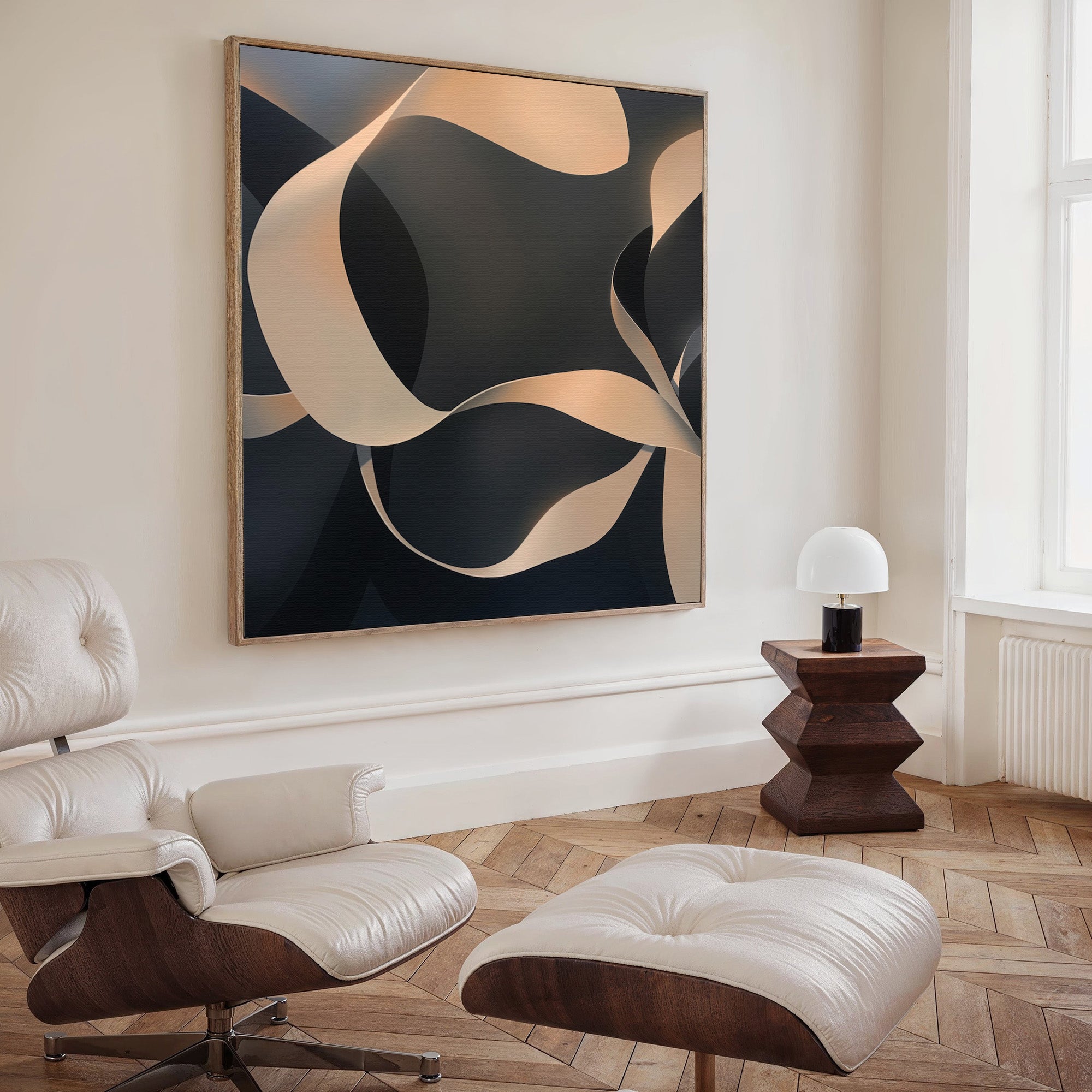 A modern living room features a white lounge chair and ottoman, a geometric wood side table with a small lamp, and the Quiet Division Abstract Canvas Art—minimalist wall decor with curved beige and dark shapes for modern elegance.