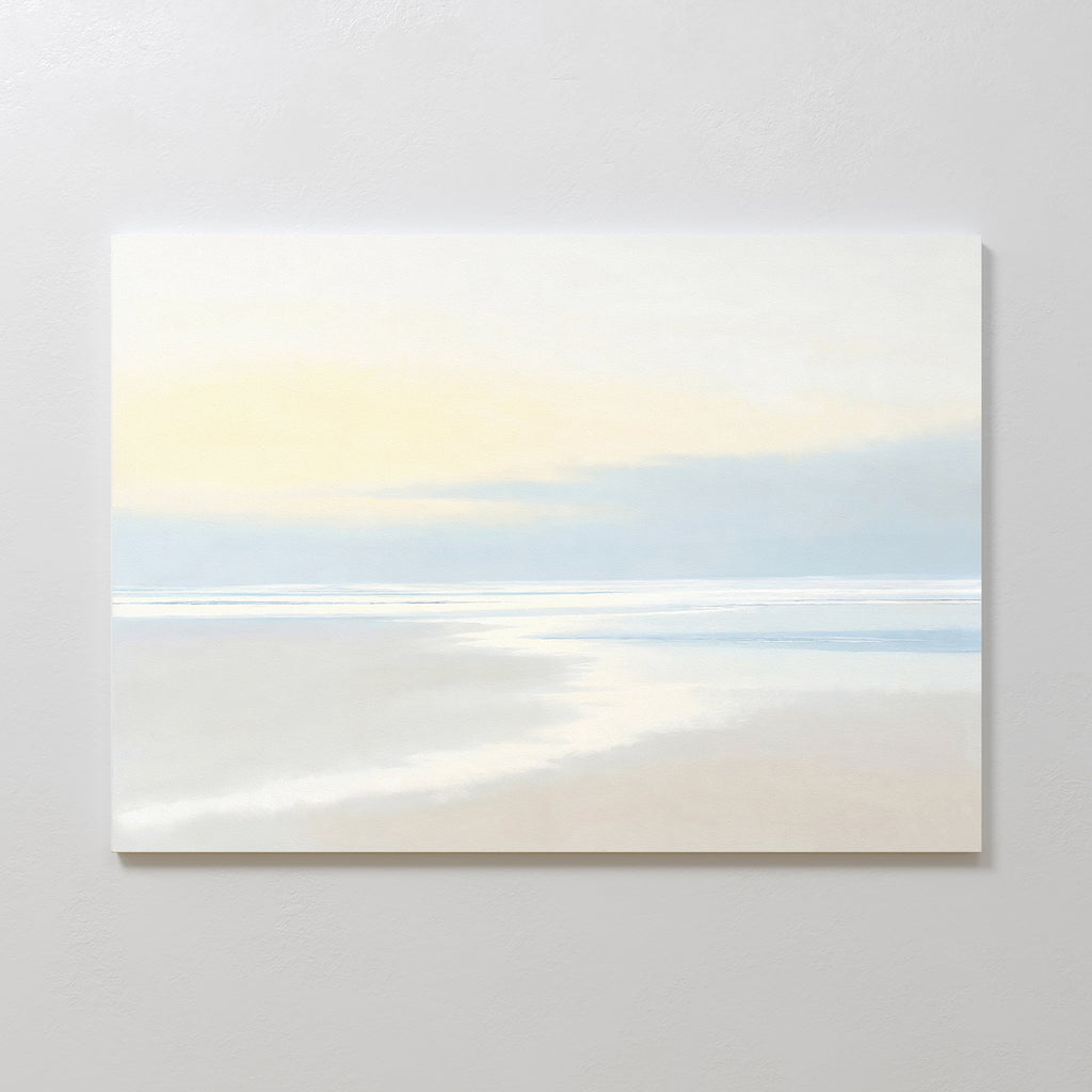 Quiet Shores Canvas Art – Horizontal features a minimalist seascape in soft, muted colors with a sandy shore, calm water, and pale sky—ideal coastal decor for adding serenity to any plain white wall.
