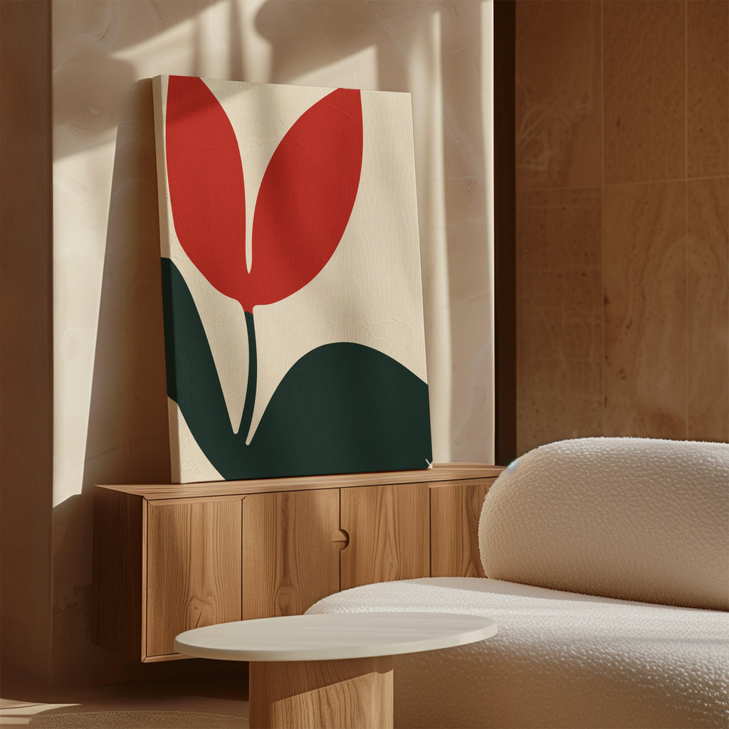 The Red Botanic Abstract Canvas Art with a minimalist red and green flower design sits on a wooden cabinet beside a textured sofa, adding stylish wall art to the neutral, sunlit living room.