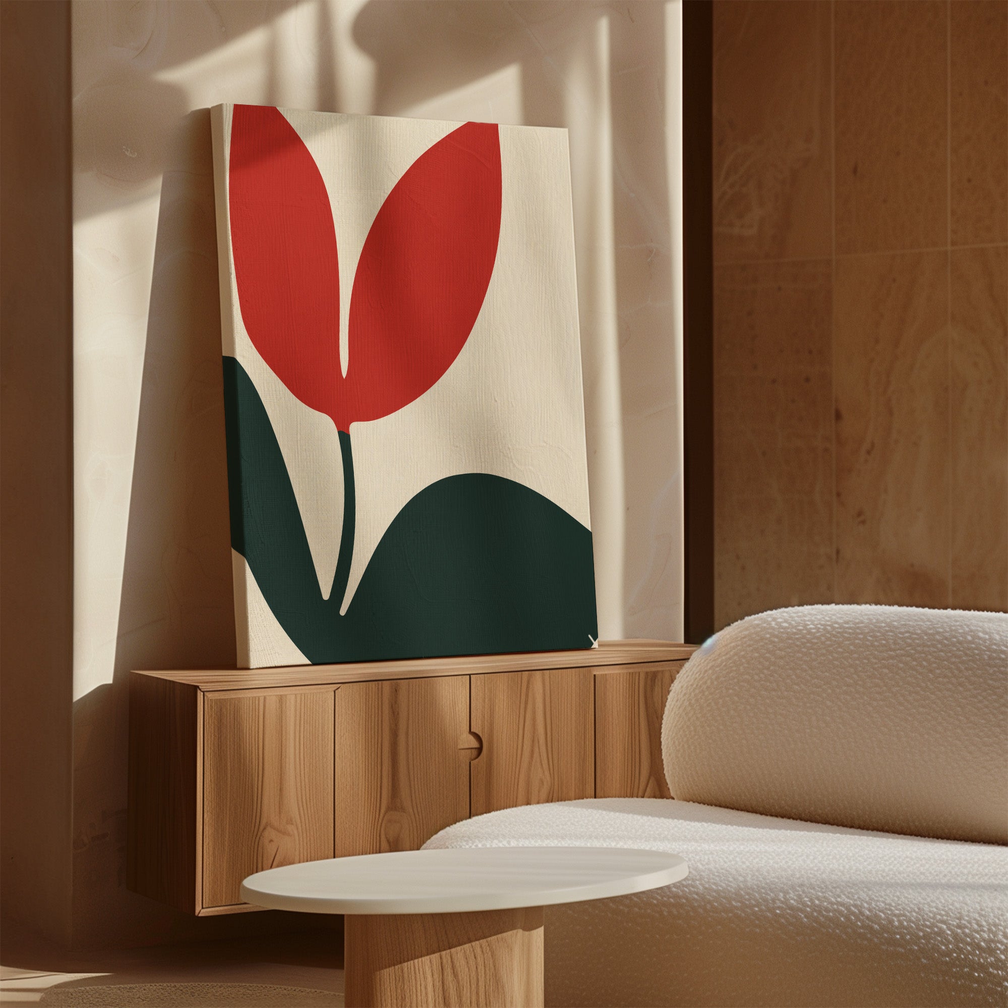 The Red Botanic Abstract Canvas Art with a minimalist red and green flower design sits on a wooden cabinet beside a textured sofa, adding stylish wall art to the neutral, sunlit living room.
