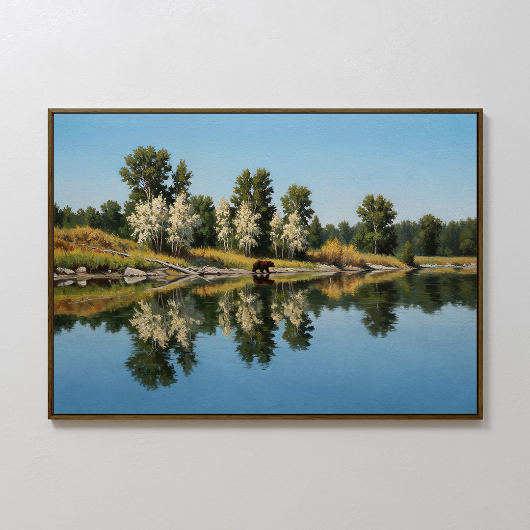 Reflections of the Wild Canvas Art features a peaceful river mirroring tall green and white trees under a blue sky, with a brown bear at the waters edge—perfect wall art for any nature-inspired space.