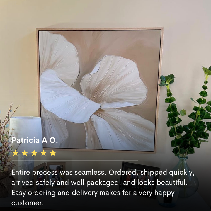 The Floral Whisper Abstract Canvas Art in neutral tones hangs above a shelf with potted plants and decor, with a five-star customer review displayed below.