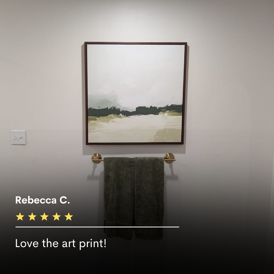 The Abstract Glade Canvas Art hangs above a towel rack with a dark green towel on a light wall. A five-star review and the words “Love the art print!” showcase this calming decor choice.