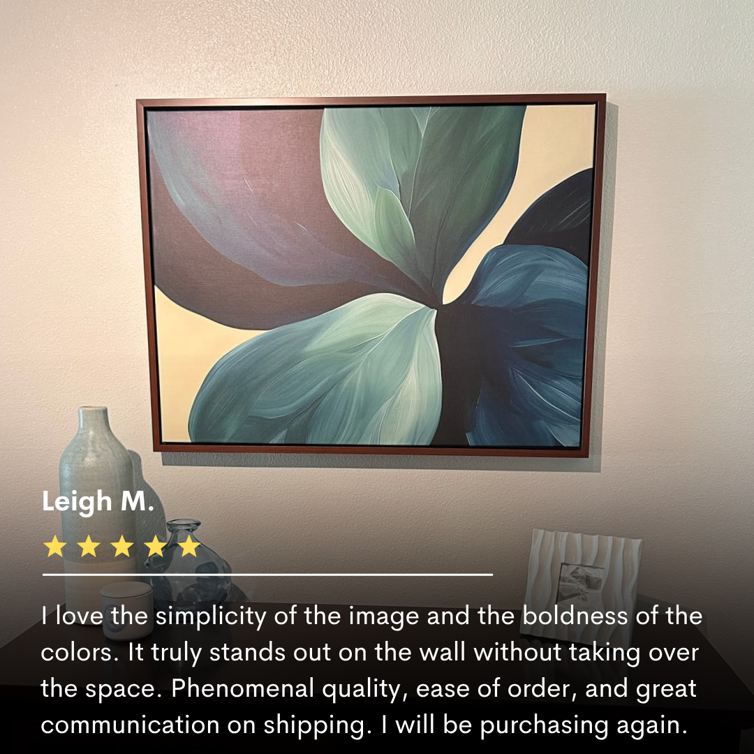 The Lush Teal Foliage Abstract Canvas Art, featuring overlapping green and blue leaves, hangs above a wooden shelf on a beige wall; perfect living room decor, it’s displayed with a vase and boasts a 5-star review.