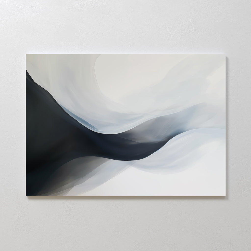 Rippling Vista Abstract Canvas Art features smooth, flowing shapes in black, gray, and white, creating a sense of movement and depth. This minimalist piece adds modern elegance to any space and looks stunning mounted on a pale wall.