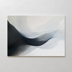 Rippling Vista Abstract Canvas Art features smooth, flowing shapes in black, gray, and white, creating a sense of movement and depth. This minimalist piece adds modern elegance to any space and looks stunning mounted on a pale wall.