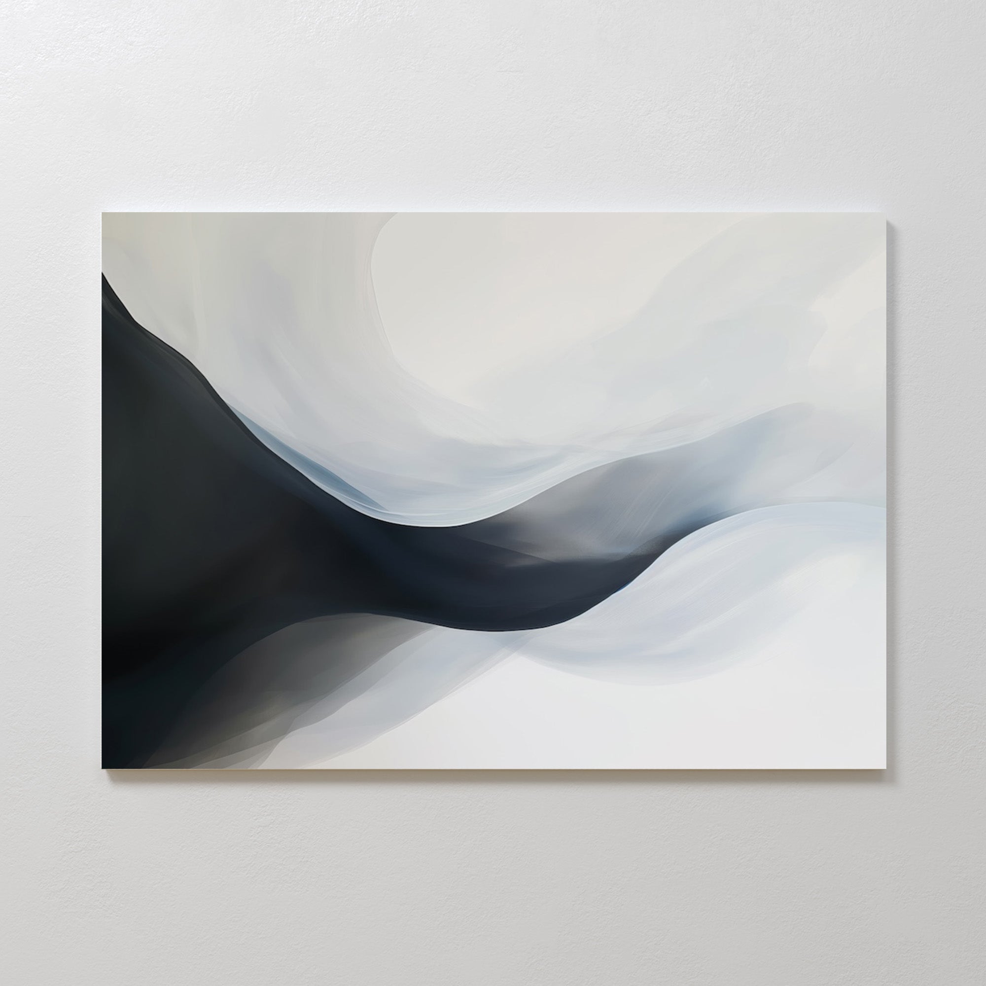 Rippling Vista Abstract Canvas Art features smooth, flowing shapes in black, gray, and white, creating a sense of movement and depth. This minimalist piece adds modern elegance to any space and looks stunning mounted on a pale wall.