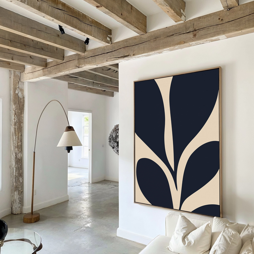 A modern living room with exposed wooden beams, a curved floor lamp, white sofa, and the Botanical Ink Abstract Canvas Art. White walls and floors create a bright, airy space ideal for stylish living room decor.