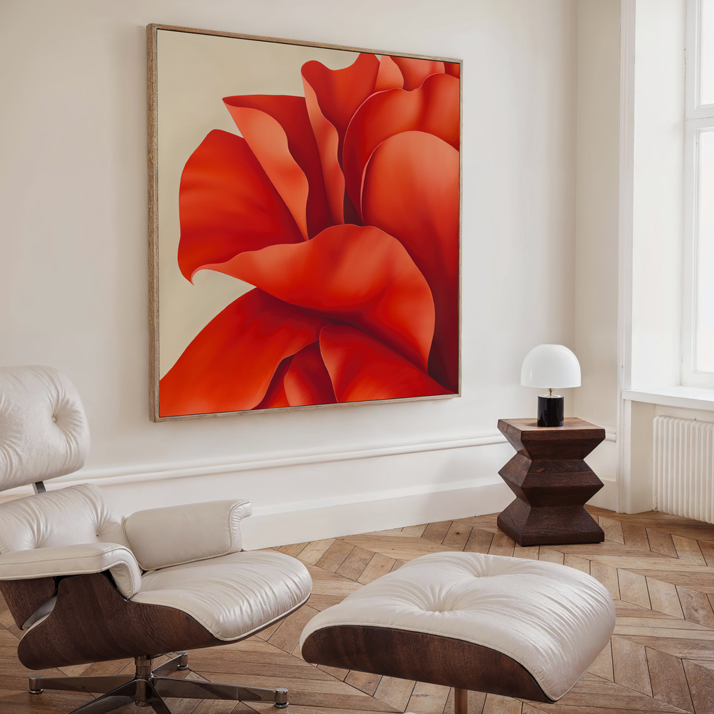 A modern, minimalist living room features a white leather lounge chair, ottoman, geometric wooden side table, small white lamp, and the Red Elegance Abstract Canvas Art—a bold and elegant accent for your decor.