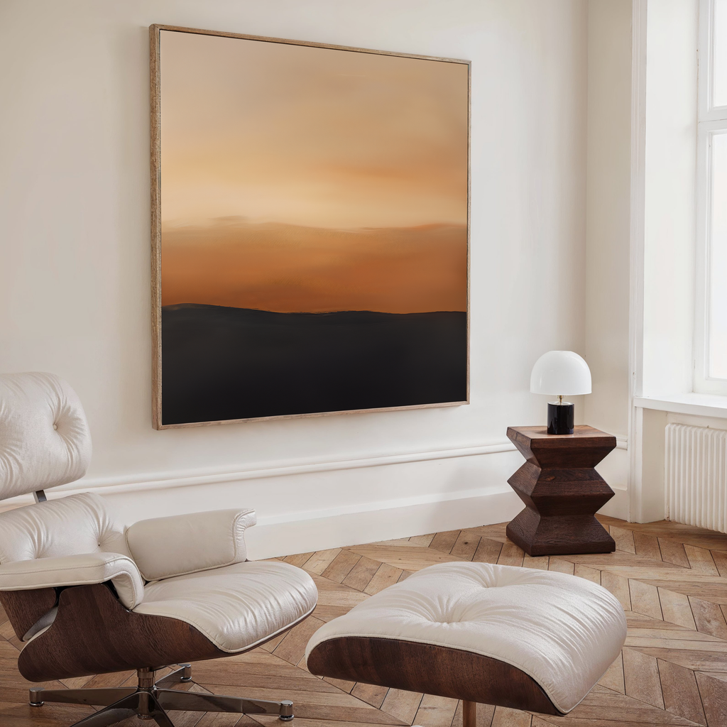 A modern room featuring a cream leather lounge chair, ottoman, geometric wood side table with white lamp, and the Tranquil Vista Abstract Canvas Art in warm brown and orange tones enhancing the living room decor.