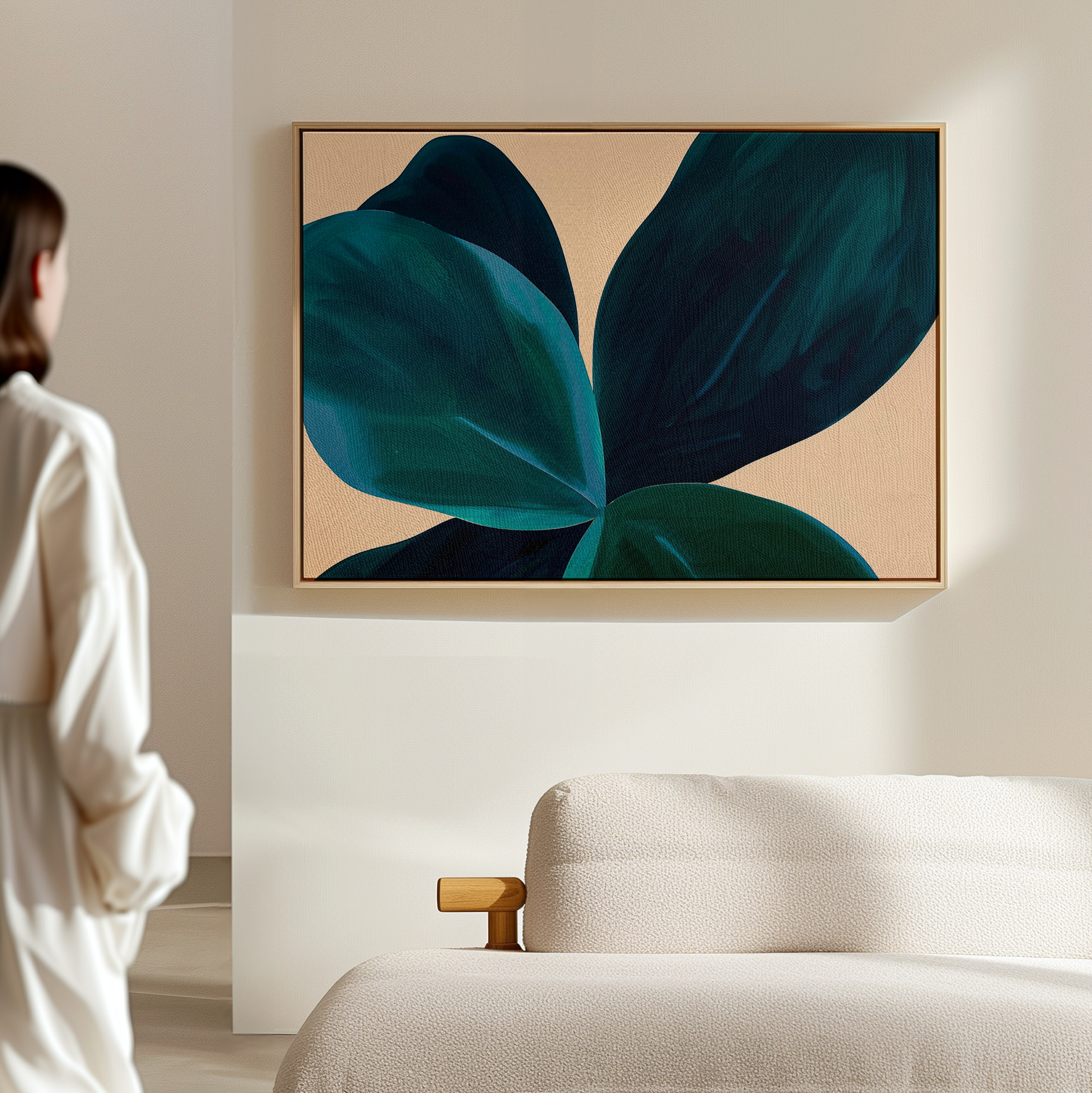 In a minimal, light-filled room, a person admires Deep Navy Abstract Canvas Art displayed above a beige textured sofa, adding elegance and modern style to the living room decor.