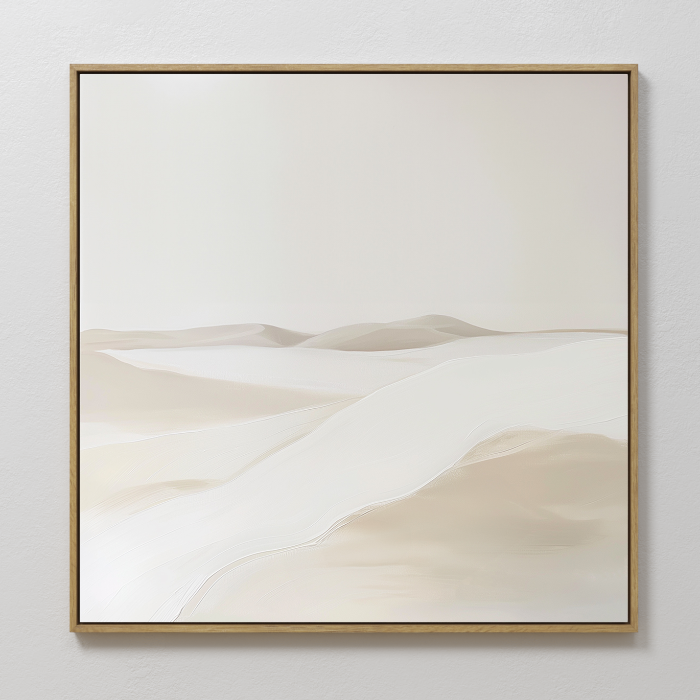 Misty Vale Abstract Canvas Art features soft, rolling sand dunes in neutral beige and white tones, framed in thin gold and displayed on a light wall—ideal for creating a serene atmosphere in your living room or bedroom.