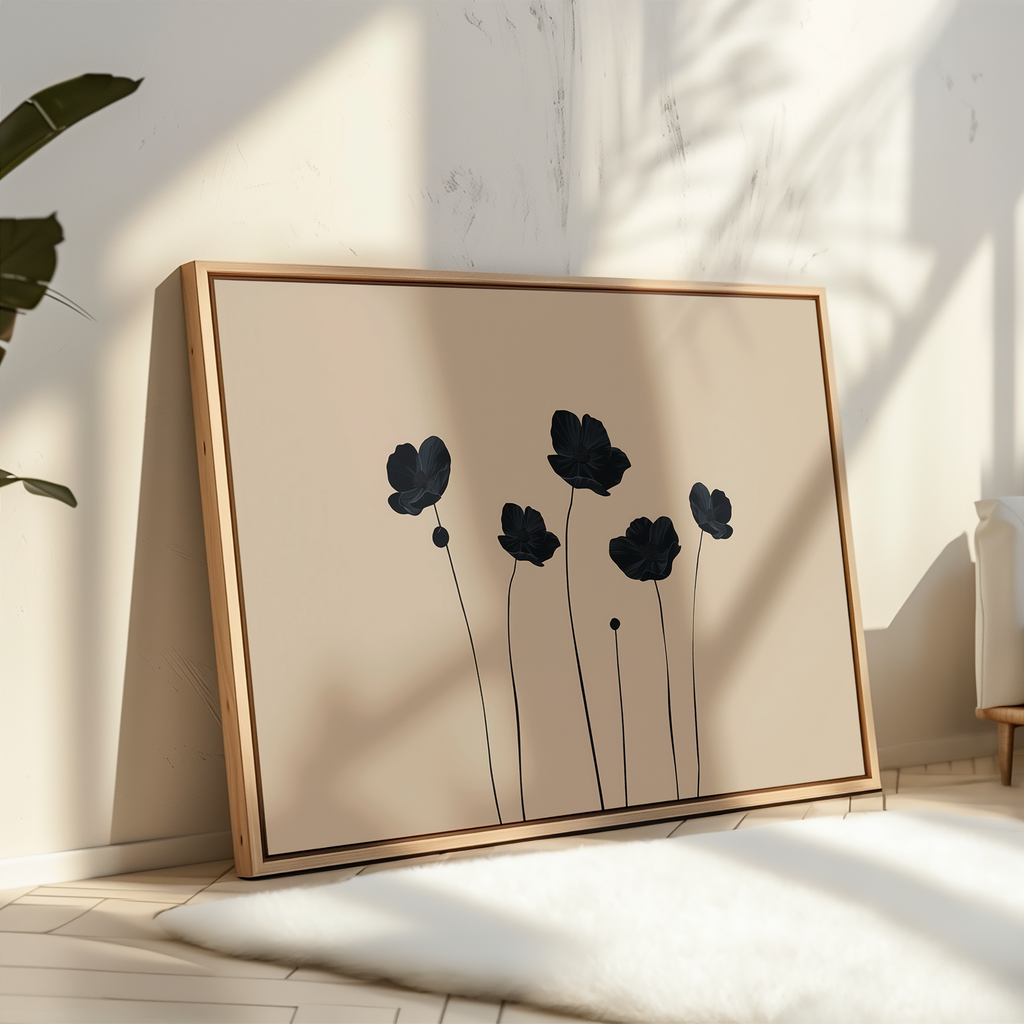 The Botanic Abstract Canvas Art showcases five black floral silhouettes on a beige background in a minimalist frame—modern wall art that brightens any room, resting stylishly against a sunlit white wall beside a white rug and leafy plant.