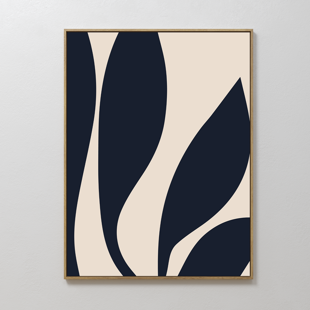 Dark Blue Leaves Abstract Canvas Art features bold, curved navy shapes on a beige background. Framed in simple wood and displayed against a white wall, this piece brings modern elegance and timeless appeal to any space.