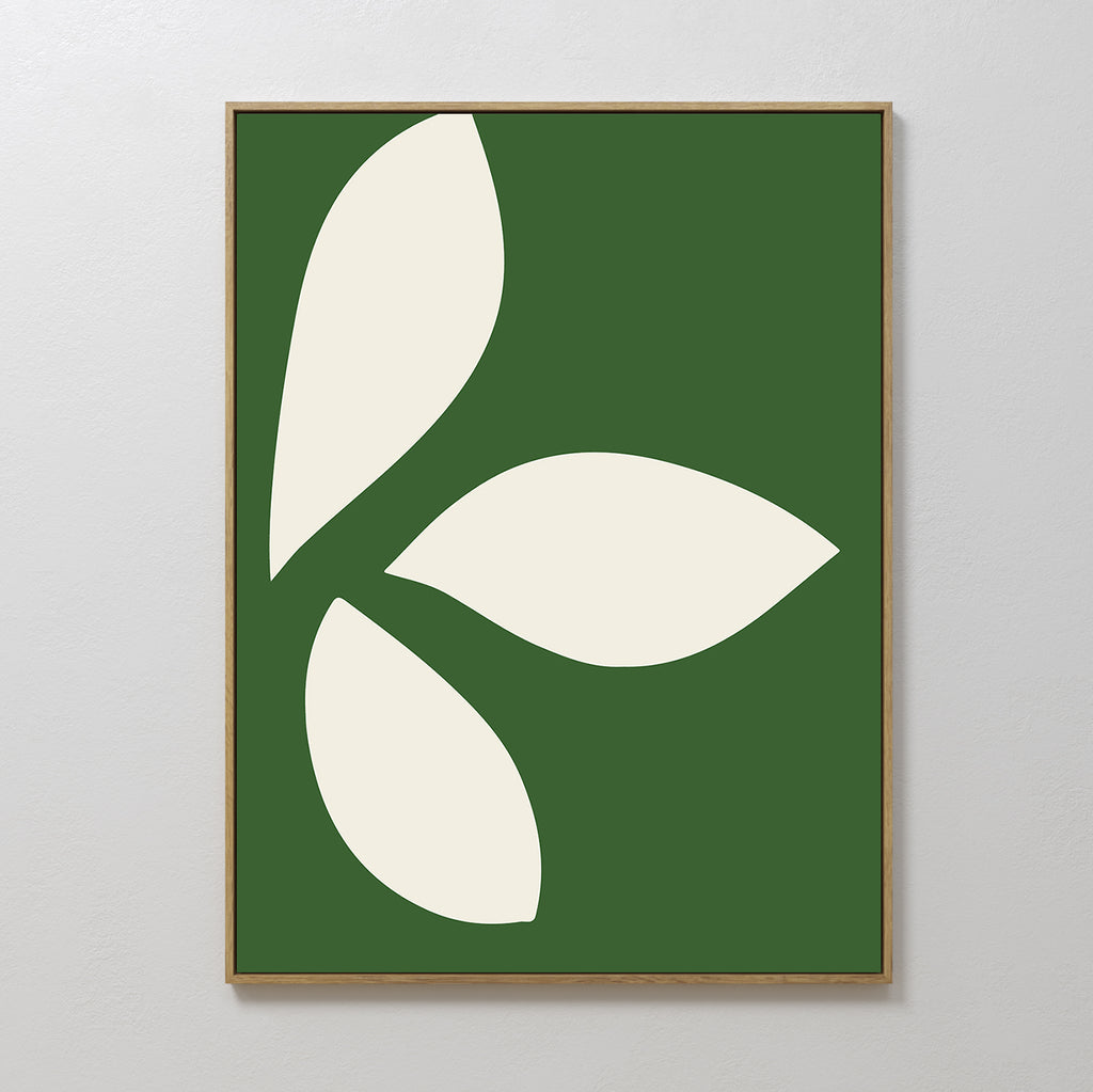 The Leaf Silhouette Abstract Canvas Art features three large cream leaf shapes on a dark green background in a simple wooden frame, bringing modern elegance and minimalist style to your living room decor.