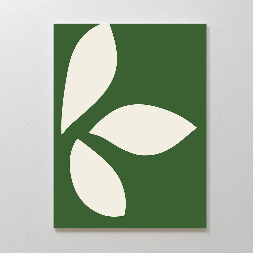 The Leaf Silhouette Abstract Canvas Art displays three large off-white leaf-like shapes on a green rectangular background, creating modern, minimalist wall decor for any plain light wall.