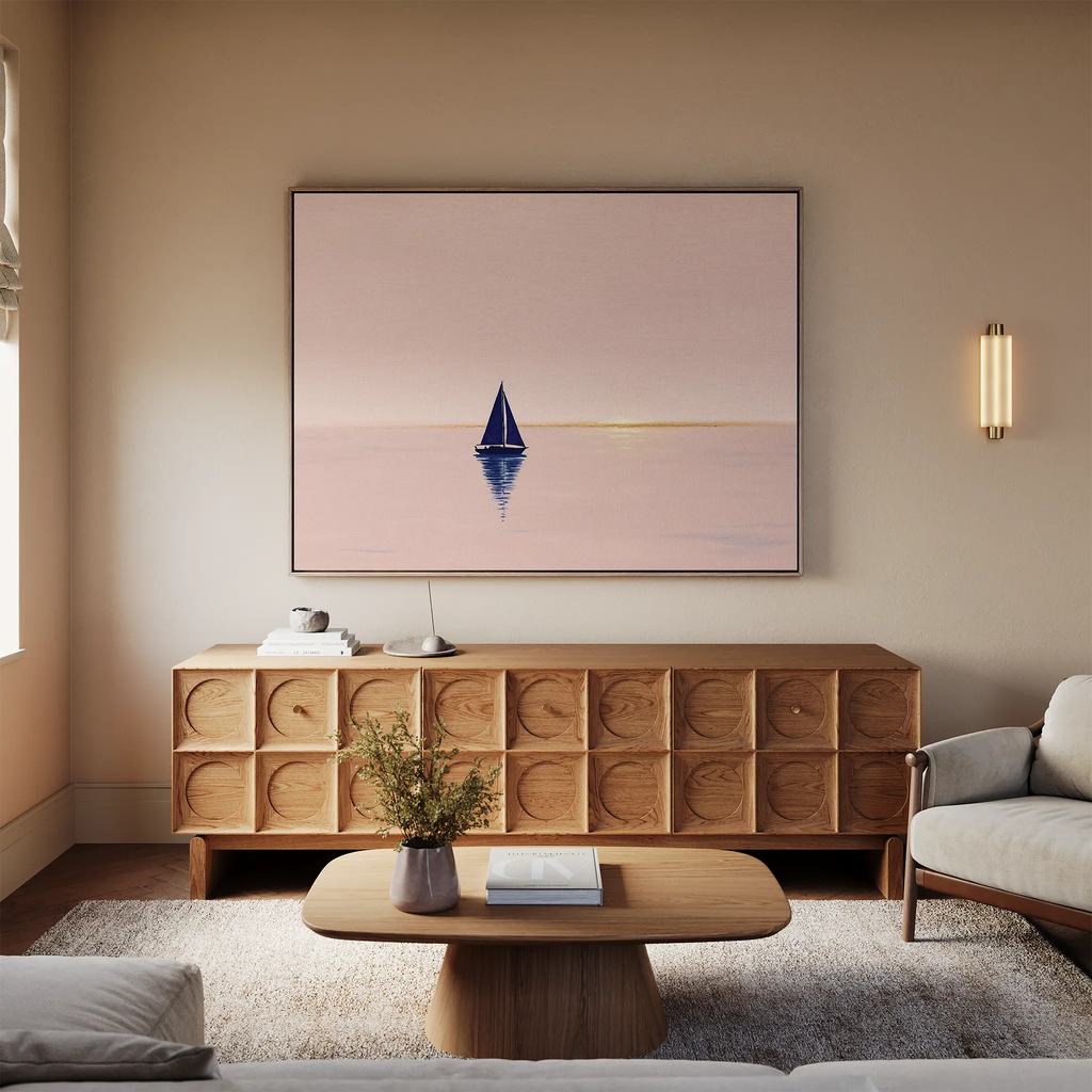 A cozy living room features light walls, a beige sofa, wooden coffee table, elegant sideboard, and calming wall art—a large Rose Harbor Canvas Art—creating serene modern decor.