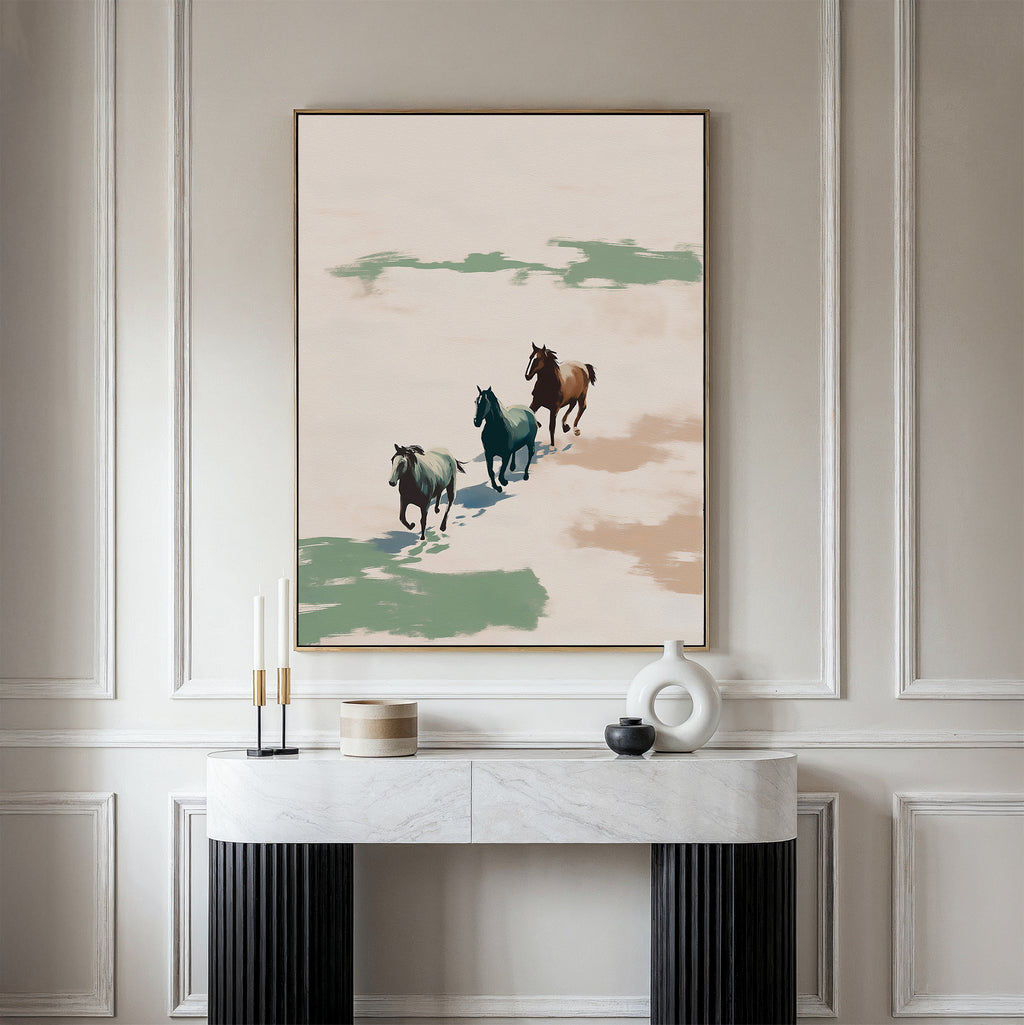 A modern living space featuring a marble console table, decorative objects, and the Running Free Canvas Art—a striking print of three horses running against a neutral background, ideal for minimalist décor enthusiasts.