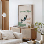 A minimal, modern living room boasts a light wood cabinet topped with the Running Free Canvas Art. A white sofa, neutral decor, a small plant, and ceramic pieces complete the calm and airy atmosphere.