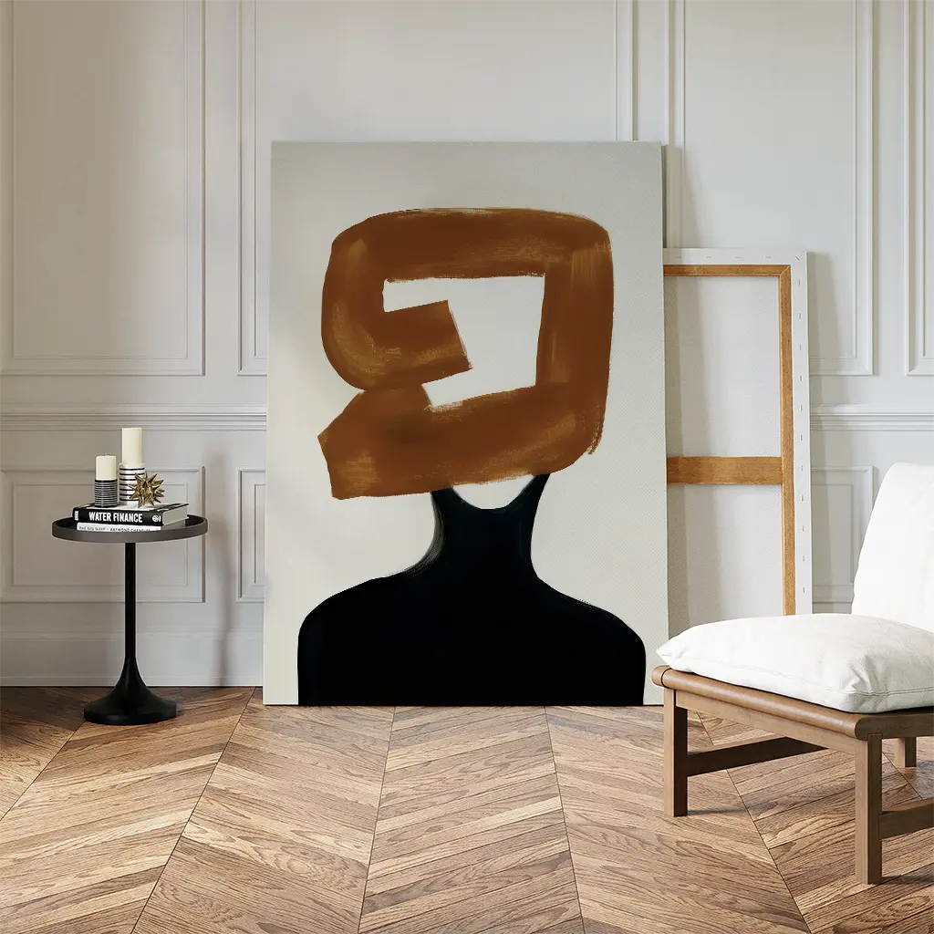 A minimalist room with herringbone wood floors, a white chair, and a side table with candles. The Rustic Persona Canvas Art, featuring abstract wall art with a modern silhouette and brown brushstroke, rests against the wall.