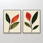The Rustic Stems Set of 2 features minimalist botanical prints with olive green and red-orange stylized leaves on a light beige background in sleek black frames—perfect rustic wall art for modern living rooms.