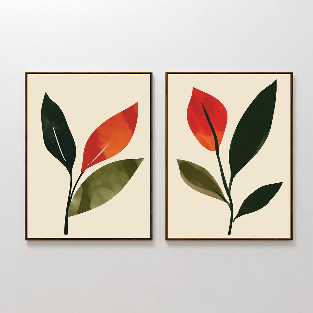 The Rustic Stems Set of 2 features minimalist framed prints with abstract green and orange leaves on a light beige background. Each print displays a single stem with overlapping leaves, ideal for modern living room decor.