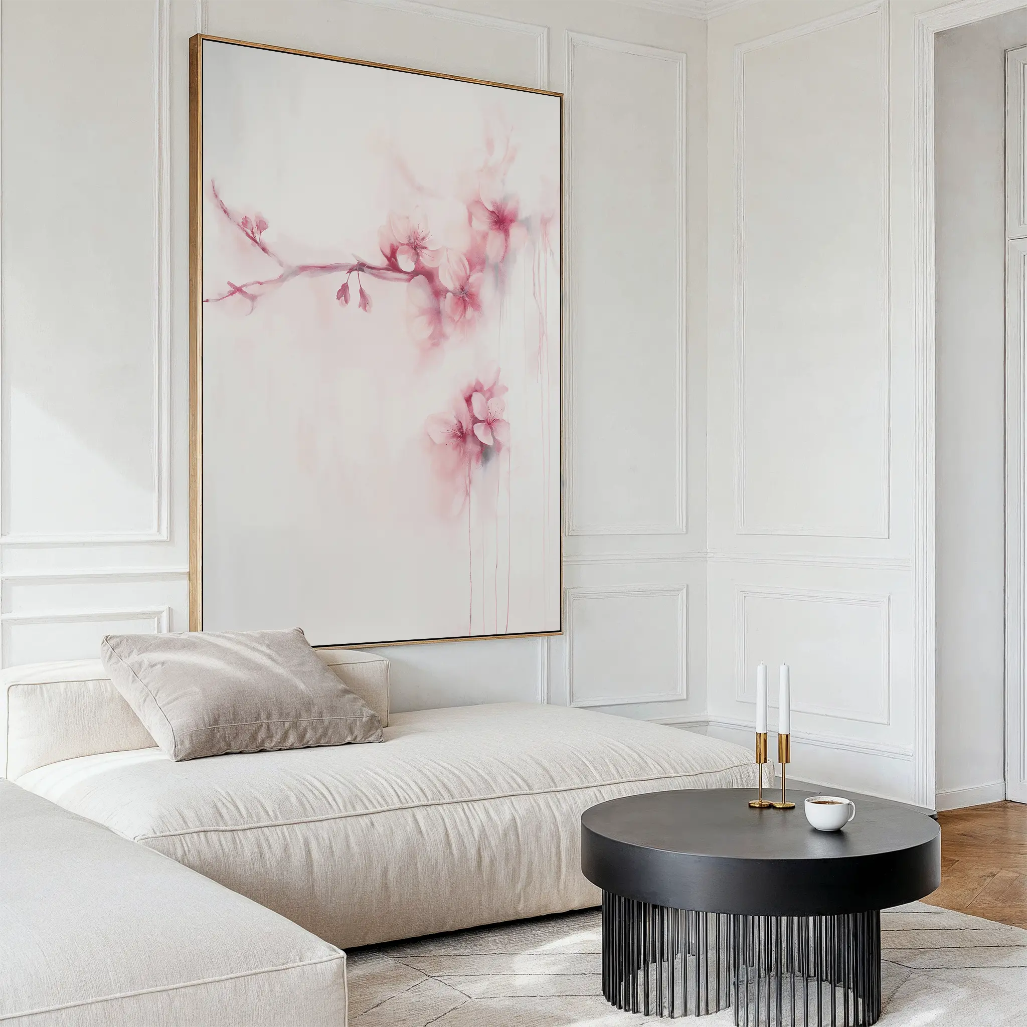 A modern living room featuring a light beige sectional sofa, a round black coffee table, and the Sakura Dream Canvas Art with pink flowers. The decor is minimal and bright, highlighting neutral tones for a serene ambiance.